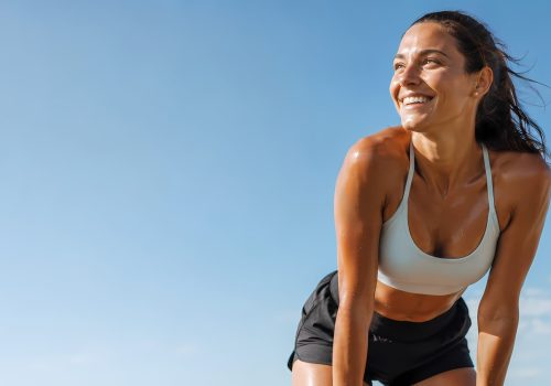 Athletic woman breathing happily after a long run